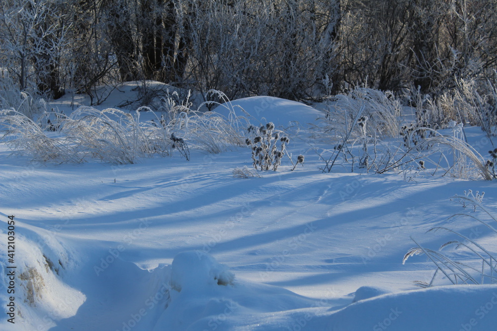 winter landscape with snow-covered grass in frost.frost and sun.mountains of snow. winter landscape with snow-covered grass in frost.frost and sun.mountains of snow.
