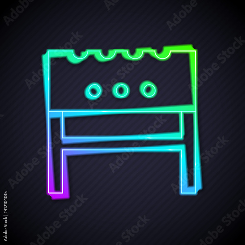 Glowing neon line BBQ brazier icon isolated on black background. Vector.