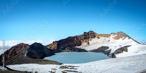 Mount ruapehu crater lake in summer with light snow photo
