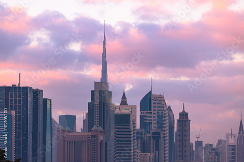 Dubai urban city skyline during vibrant sunset with clouds