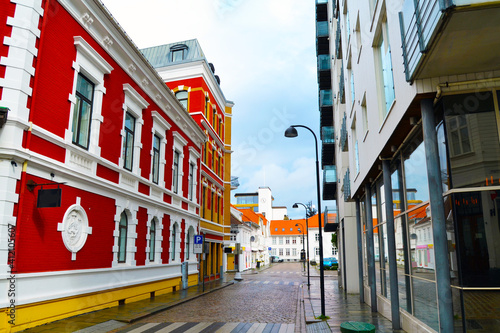 Narrow cobblestone street of Stavanger with historic and modern buildings. Norway, Rogaland county
