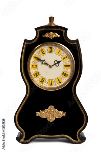 The black clock is old. Watch dial with Roman numerals. Clock isolated on white background.