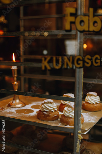 fresh semla bun near a burning candle photo