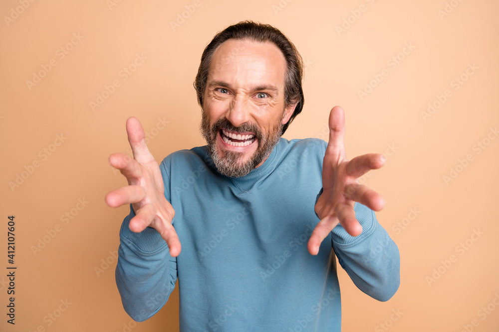 Photo portrait of angry man ready to choke you isolated on pastel beige colored background Photo portrait of angry man ready to choke you isolated on pastel beige colored background