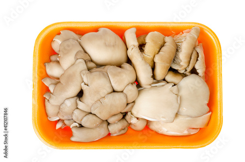 Fresh raw oyster mushrooms in package on white background