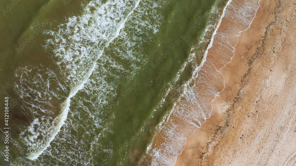 Aerial view of the sandy beach and sea waves. Vacation at sea Aerial view of the sandy beach and sea waves. Vacation at sea