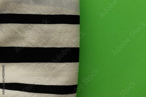 Black and white cloth of tallit made of sheep's wool, green background