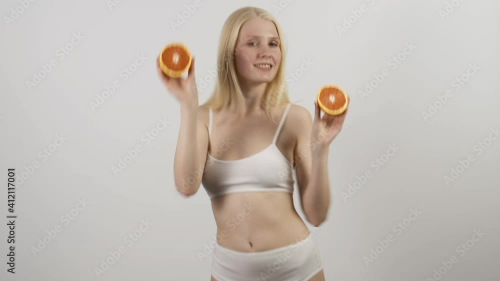 Healthy eating, diet. Beautiful healthy girl with slices of red grapefruit, food, cosmetics concept Healthy eating, diet. Beautiful healthy girl with slices of red grapefruit, food, cosmetics concept