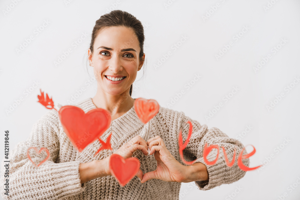 Beautiful smiling young woman in love drawing hearts Beautiful smiling young woman in love drawing hearts
