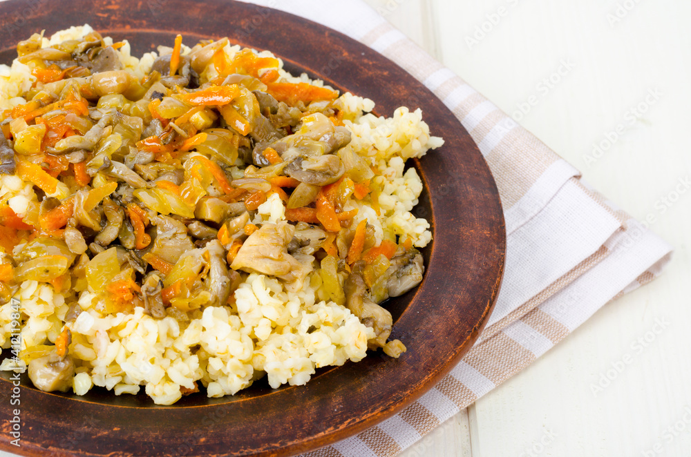 Tasty boiled porridge with vegetables and mushrooms. Tasty boiled porridge with vegetables and mushrooms.