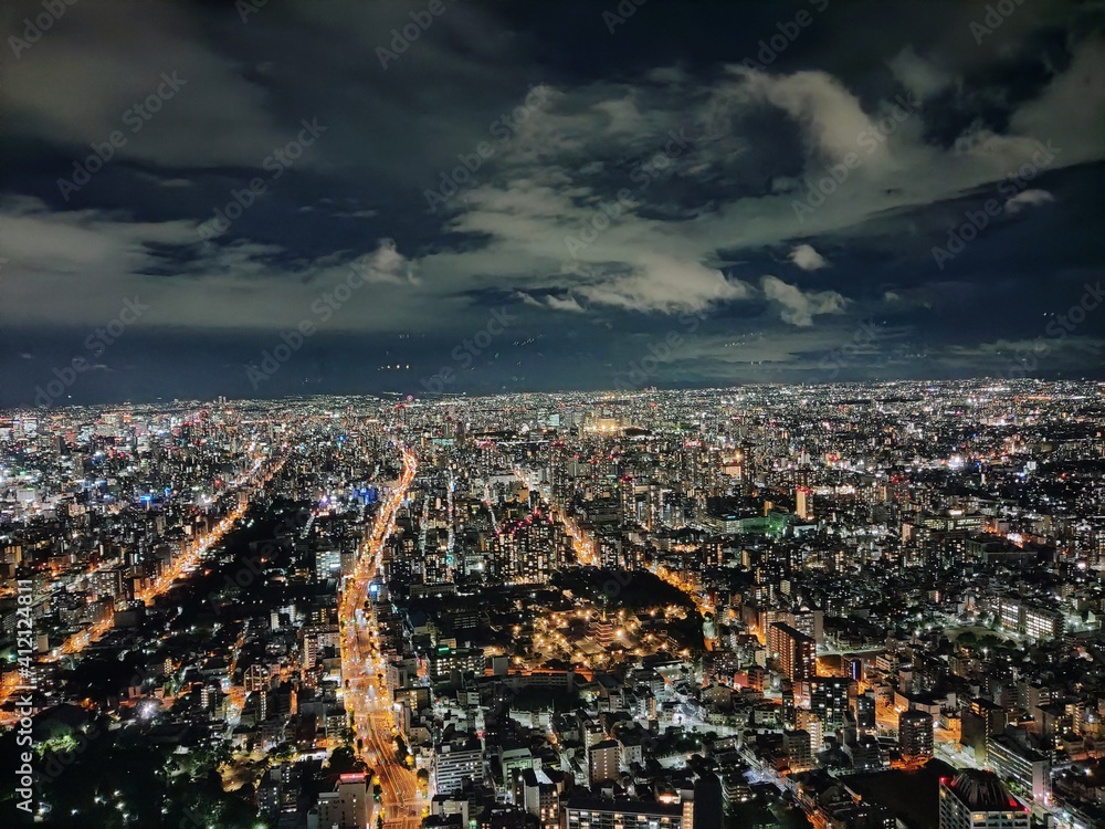 High Angle View Of Illuminated Cityscape Against Sky At Night