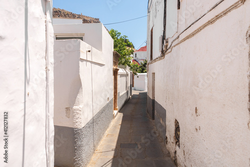 Narrow streets of the southern resort town. The white walls of the houses.