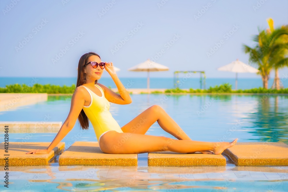 Portrait beautiful young asian woman relax smile enjoy leisure around swimming pool