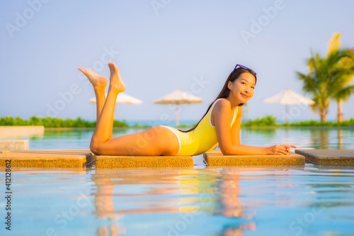 Portrait beautiful young asian woman relax smile enjoy leisure around swimming pool © siraphol