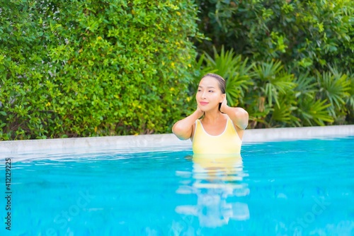 Portrait beautiful young asian woman relax smile enjoy leisure around swimming pool