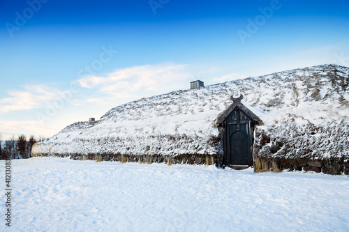 Icelandic Viking house, covered in snow, frozen at the bottom of the roof.