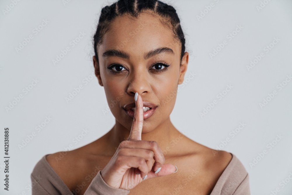 Beautiful african american woman showing silence gesture at camera Beautiful african american woman showing silence gesture at camera