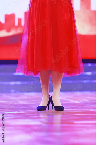 Red skirt and high heels on stage