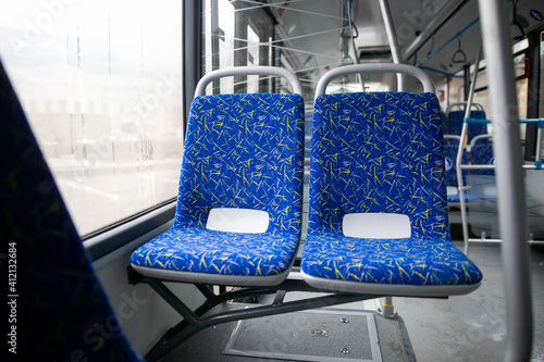 Empty bus interior. Blue seats without passengers. Public transport. Transportation of passengers by public transport. Ergonomic interior of the bus. Travel to other cities.