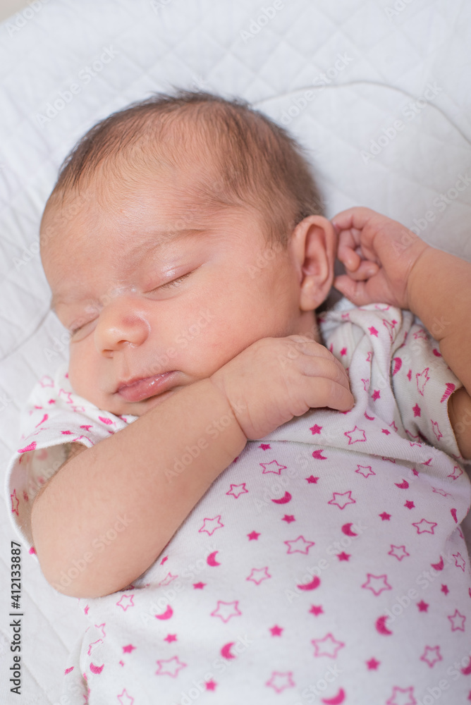 Cute, small and adorable newborn baby girl sleeping