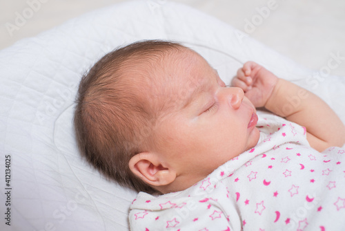 Cute, small and adorable newborn baby girl sleeping