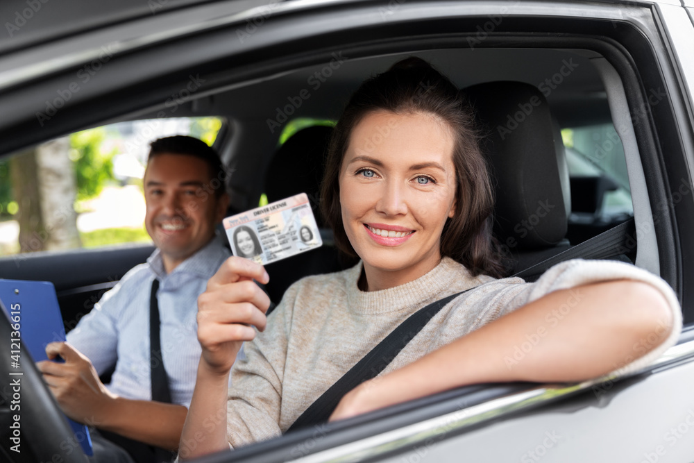 driver courses, exam and people concept - young woman with license and driving school instructor with clipboard in car - obrazy, fototapety, plakaty 