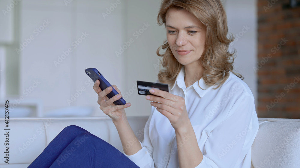 Woman sitting on couch buys online. High quality photo Woman sitting on couch buys online. High quality photo