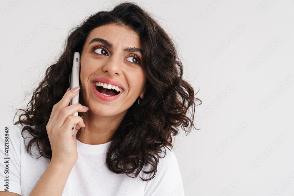 Joyful brunette girl laughing and talking on mobile phone Joyful brunette girl laughing and talking on mobile phone