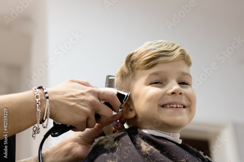 Happy boy at hairdressers.