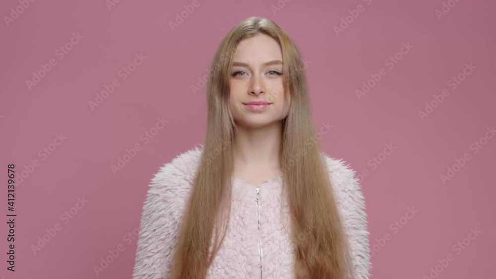 Portrait Happy Young Girl with Long Blonde Hair Dances Nods to Rhythm to Music on Pink Background. Funny Dancing Teen Slow Motion. Fashion. Glamour. Positive Emotions of People. Freedom Portrait Happy Young Girl with Long Blonde Hair Dances Nods to Rhythm to Music on Pink Background. Funny Dancing Teen Slow Motion. Fashion. Glamour. Positive Emotions of People. Freedom