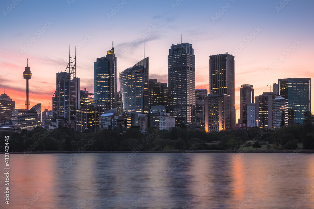 Fototapeta premium Summer sunset or sunrise cityscape waterfront view from Mrs Macquarie's Chair of the downtown Sydney central business district (CBD) city skyline in NSW, Australia.