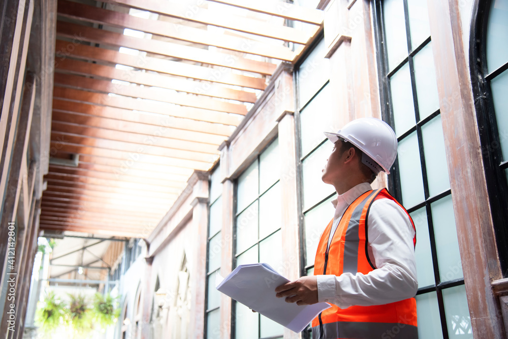 Internal Audit Engineering construction engineer hand holding blueprint inside building structure Internal Audit Engineering construction engineer hand holding blueprint inside building structure