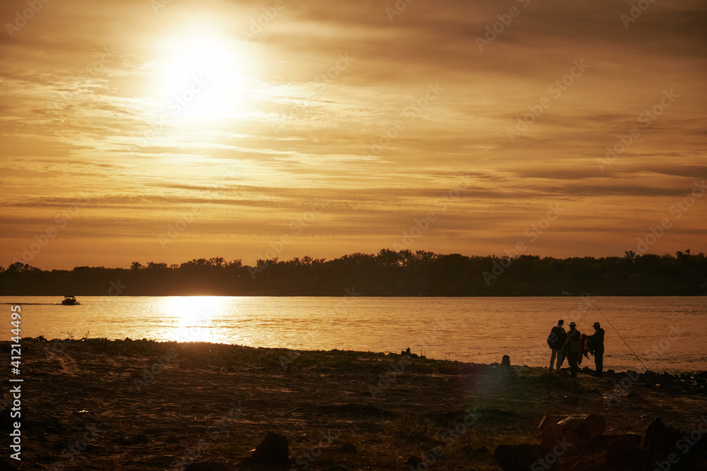 Fishermen at sunset, fishing on the river