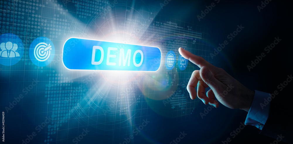 A businessmans hand selecting a DEMO business word concept on a computer display.
