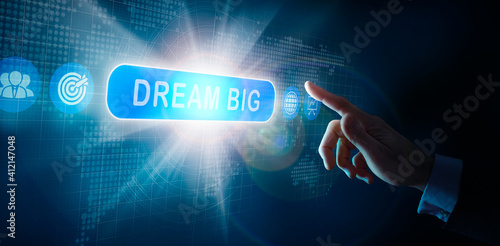 Photos A businessmans hand selecting a Dream Big business word concept on a computer display