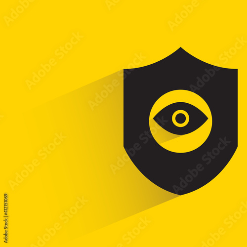 security shield and eye scanner drop shadow on yellow background