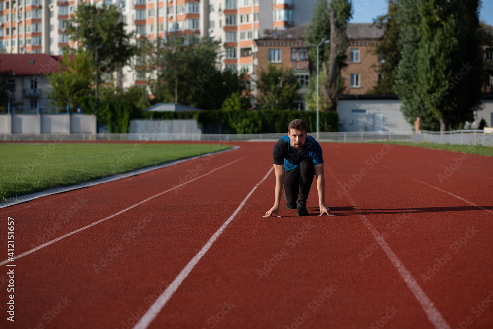 Concentrated guy is ready to run at the stadium Concentrated guy is ready to run at the stadium