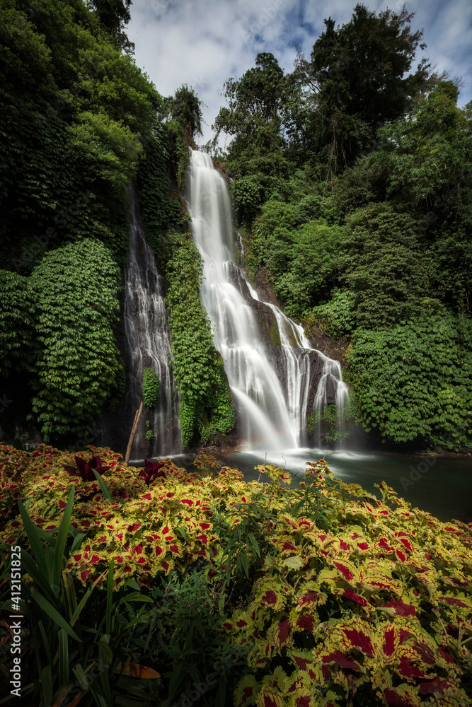 Fototapeta premium Banyumala waterfall in the north of Bali, that is in Singaraja near Lovina. Jungle waterfall cascade in tropical rainforest with rock and turquoise blue pond. its a twin waterfall in the mountain 