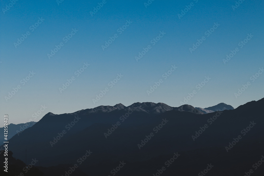 Scenery of panorama blue tone mountain background.