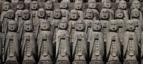 Photography Japanese small praying Buddha statues at temple in Kamakura, Japan