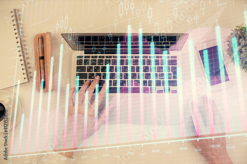 Double exposure of woman hands working on computer and forex chart hologram drawing. Top View. Financial analysis concept. © peshkova