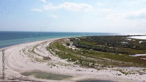 aerial view of the island in the middle of the blue sea
