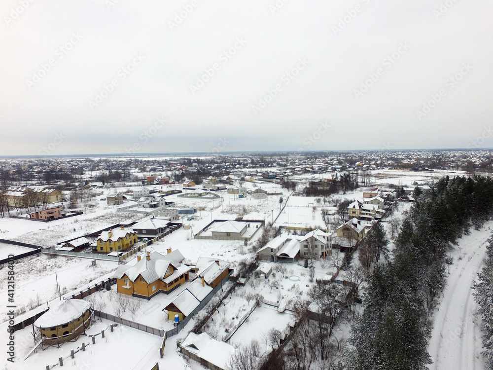 Aerial view of the countryside with the snow at winter time (drone image).  Saburb of Kiev,Ukraine
