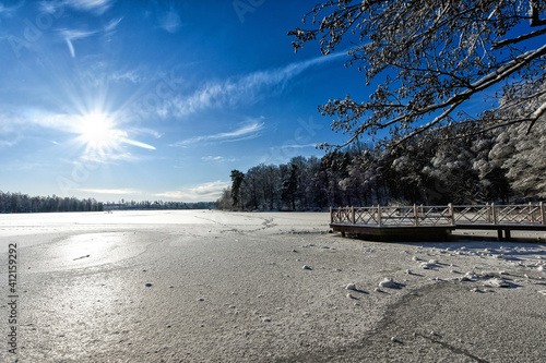 Beautiful sunny scenery of frozen lake photo