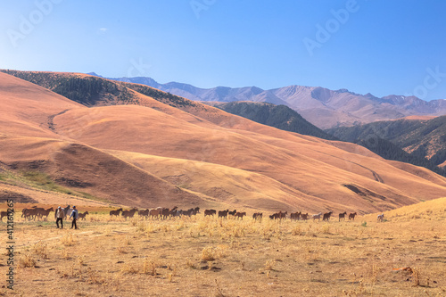 Sweeping landscape of the Assy Plateau, a large mountain steppe valley and summer pasture with herdsmen and horses 100km from Almaty, Kazakhstan.