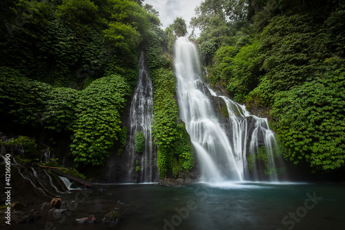 Banyumala waterfall in the north of Bali, that is in Singaraja near Lovina. Jungle waterfall cascade in tropical rainforest with rock and turquoise blue pond. its a twin waterfall in the mountain 