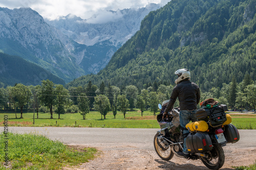 Motorcyclist man and Adventure Motorbike with bags. Motorcycle trip. World Traveling  Lifestyle Travel vacations sport outdoor concept  copy space. Zgornje Jezersko Slovenia