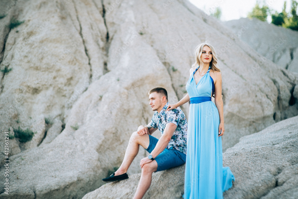 blonde girl in a light blue dress and a guy in a light shirt in a granite quarry blonde girl in a light blue dress and a guy in a light shirt in a granite quarry