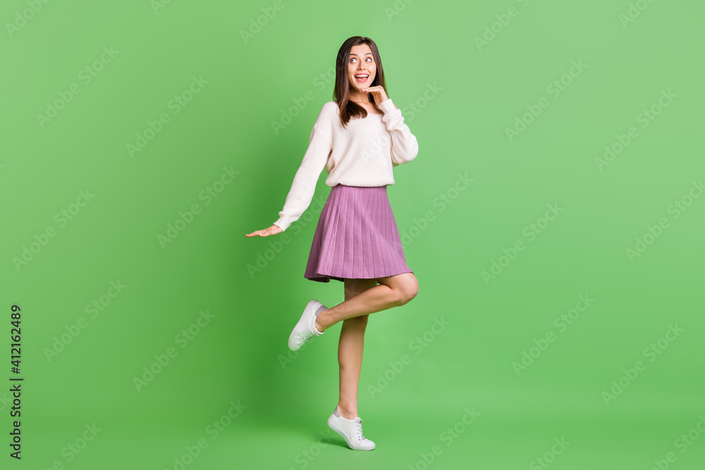 Full size photo of young attractive lovely smiling dreamy girl dancing look copyspace isolated on green color background Full size photo of young attractive lovely smiling dreamy girl dancing look copyspace isolated on green color background