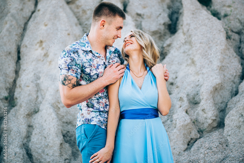 blonde girl in a light blue dress and a guy in a light shirt in a granite quarry blonde girl in a light blue dress and a guy in a light shirt in a granite quarry